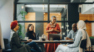 An international group of development professionals gather at a table.