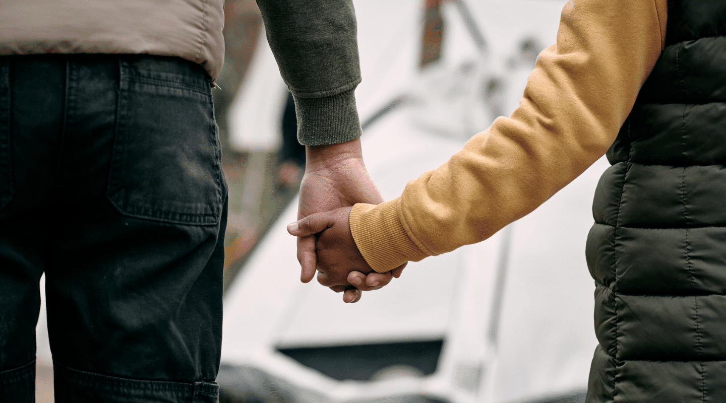 Holding hands in a refugee camp.