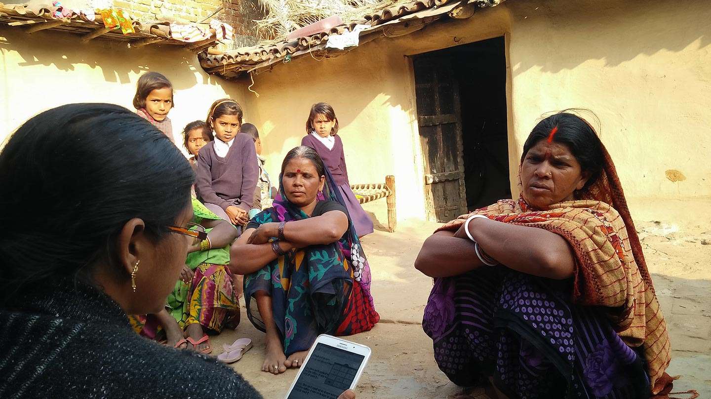 An enumerator carrying out a household survey